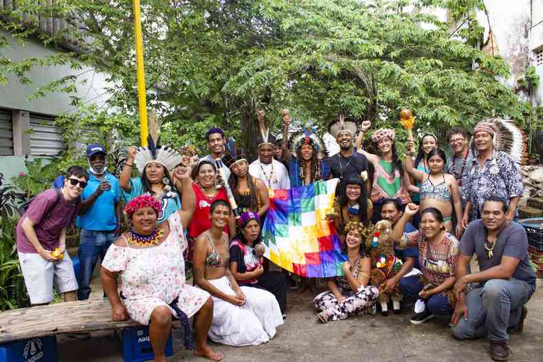 Grupo de indgenas de diversas etnias segura a bandeira wiphala ao centro.