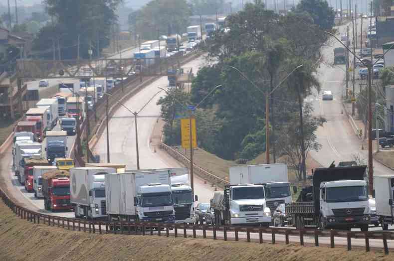 Caminhes em fila, circulando na estrada