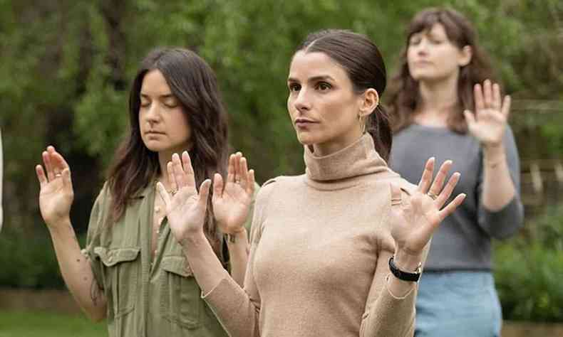 Com as mãos viradas para a câmera, três mulheres fazem exercício terapêutico em cena da série 'goop lab'