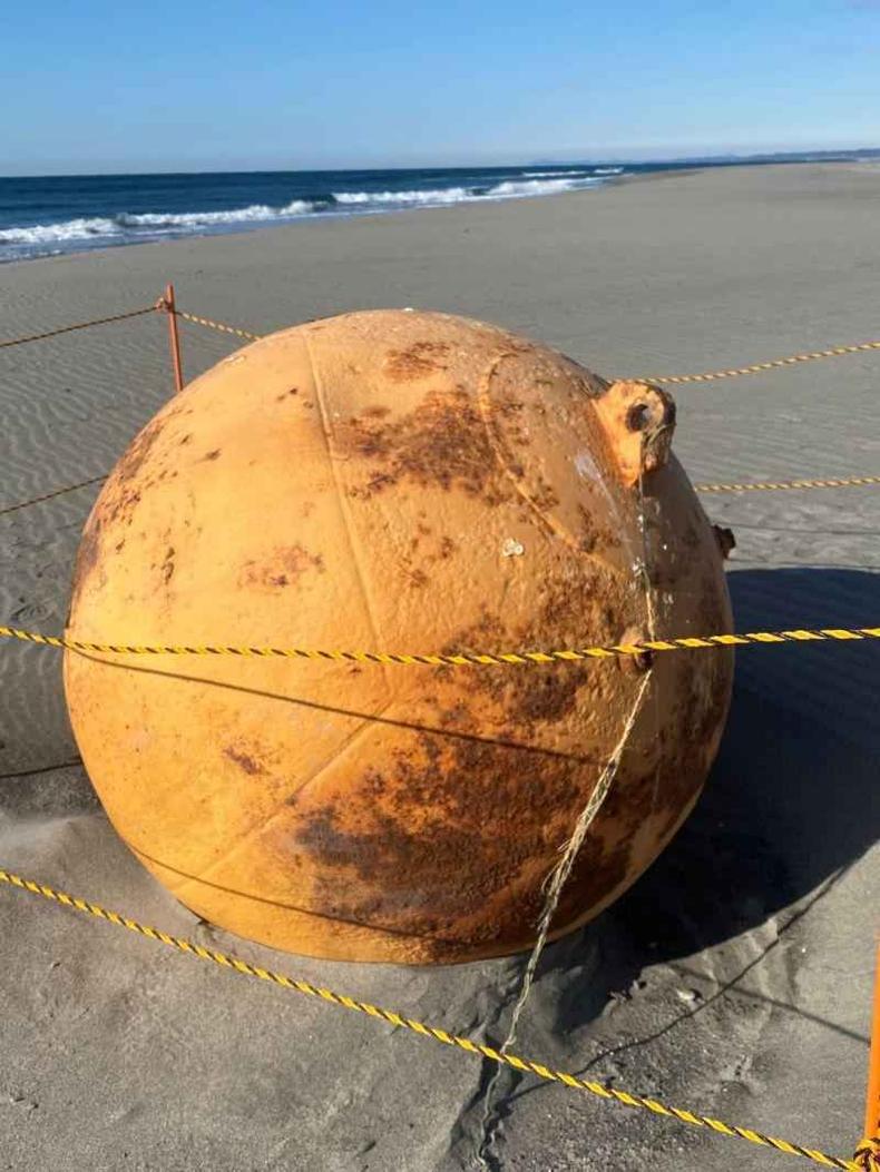 As autoridades chegaram a isolar a área, mas acabaram concluindo que a esfera não representava perigo(foto: Getty Images) Esfera metálica em areia da praia