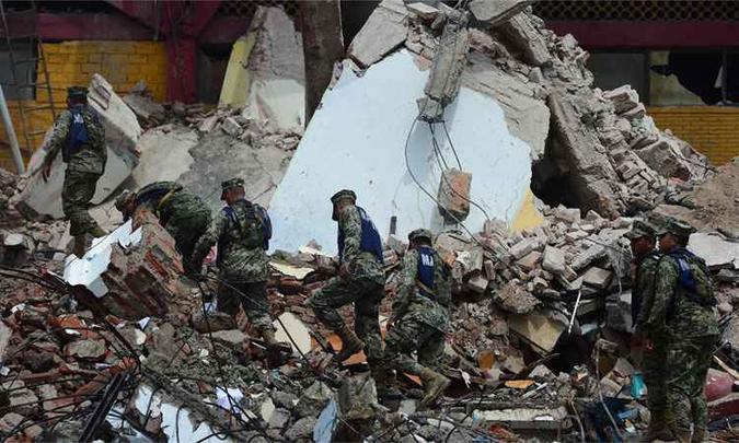 Membros da Marinha mexicana andam em meio a escombros do prédio da Câmara Municipal, que se derrubaram parcialmente após terremoto(foto: AFP / PEDRO PARDO ) Membros da Marinha mexicana andam em meio a escombros do prédio da Câmara Municipal, que se derrubaram parcialmente após terremoto(foto: AFP / PEDRO PARDO )