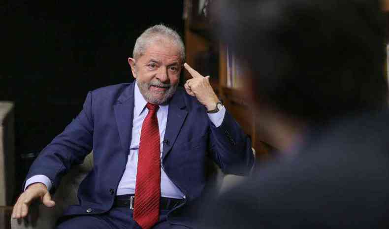 Lula de terno em entrevista apontando para a prpria cabea