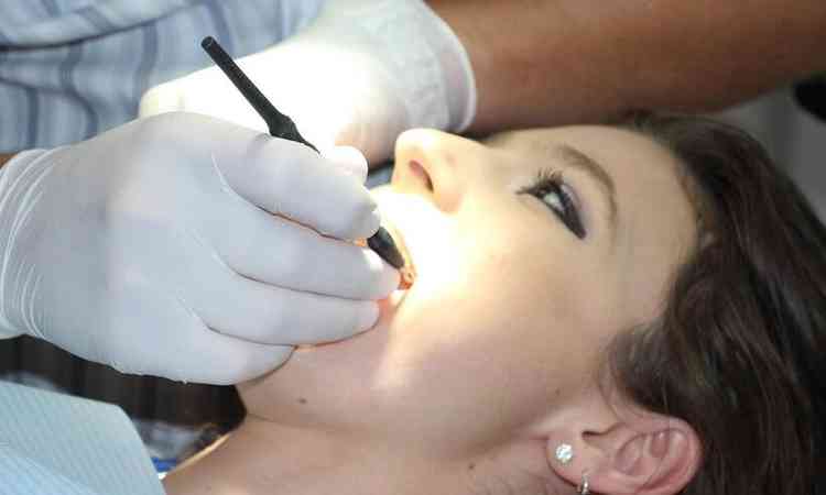 paciente sendo atendida por uma dentista