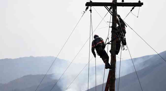 Funcionrios de empresa fornecedora de energia eltrica comearam ontem mesmo a reparar fiao destruda pelas chamas(foto: Gladyston Rodrigues/EM/D.A Press)