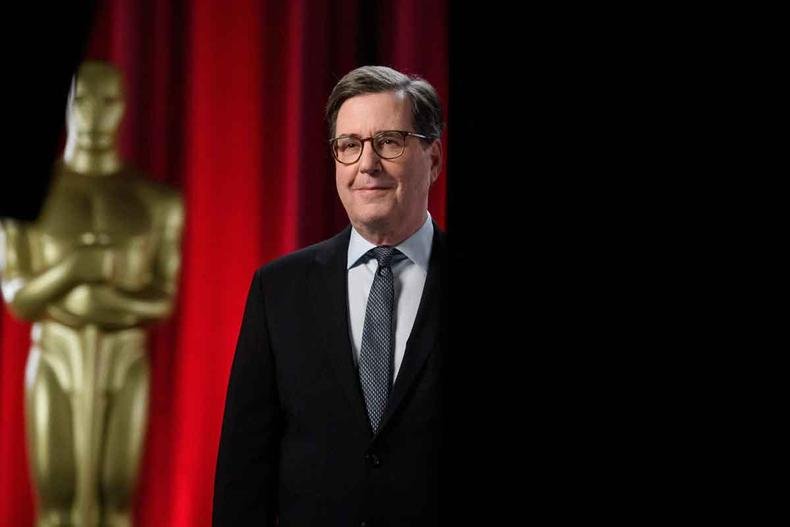 David Rubin, presidente da Academia de Artes e Ciências Cinematográficas, anunciou a novidade em e-mail (foto: Phil McCarten/AFP) David Rubin, presidente da Academia de Artes e Ciências Cinematográficas, posa em cenário vermelho ao lado de imagem do Oscar