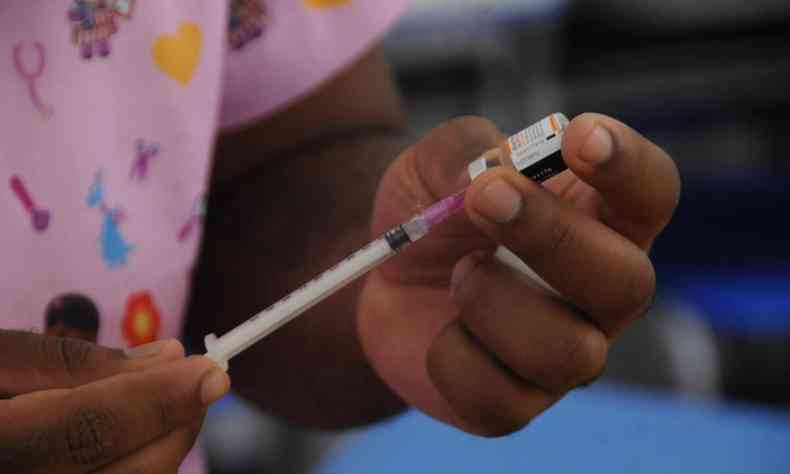 Dose de vacina contra Covid  preparada em seringa por enfermeira