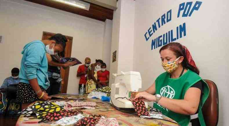 Educadora social Magali Carvalho mostra s adolescentes como fazer a mscara com materiais simples: leno e elsticos(foto: Foto: Leandro Couri EM/D.A Press)