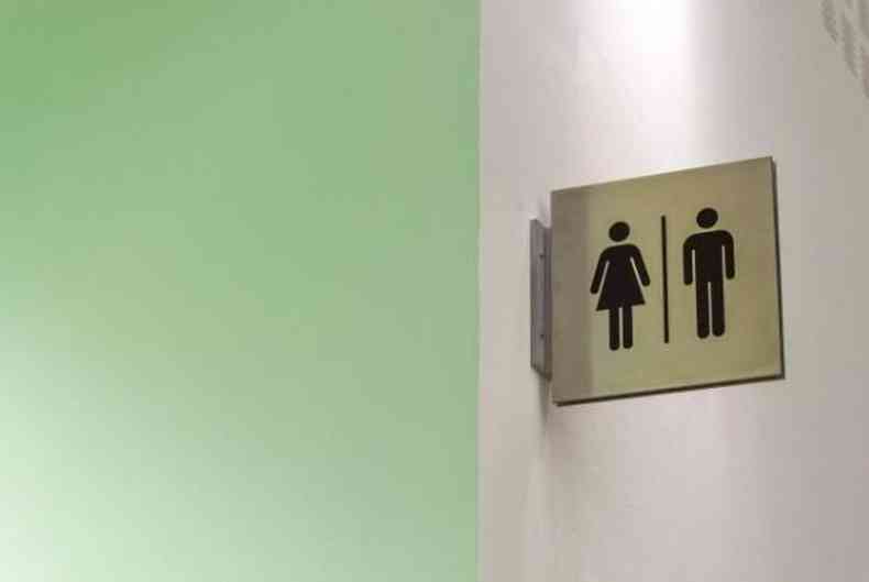 Imagem meramente ilustrativa mostra placa identificando banheiros feminino e masculino 