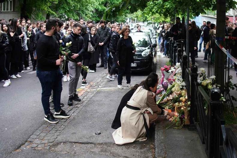 Flores e velas são colocadas na porta da escola onde 8 crianças e um segurança foram mortos por menino de 13 anos(foto: OLIVER BUNIC / AFP) Flores e velas são colocadas na porta da escola onde 8 crianças e um segurança foram mortos por menino de 13 anos