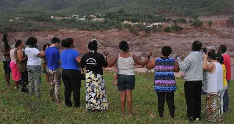 Atingidos do rompimento da barragem do Fundo rezam oram de mos dadas nas ruinas de Bento Rodrigues