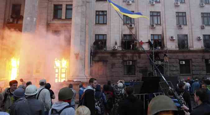 Pessoas tentam fazer o resgate em prdio que pega fogo aps confrontos na cidade de Odessa(foto: Yevgeny Volokin/Reuters)