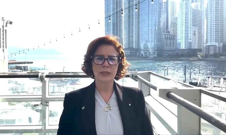 Carla Zambelli usando blusa branca, blazer preto e �culos em paisagem da cidade de Busan, na Coreia do Sul