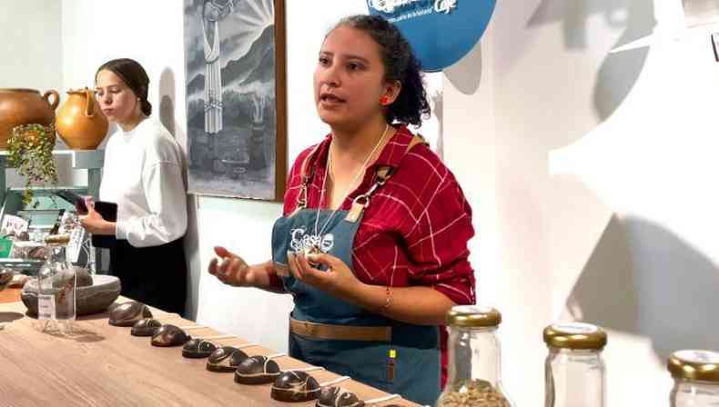 Andrea Izquierdo gesticulando em frente a uma mesa