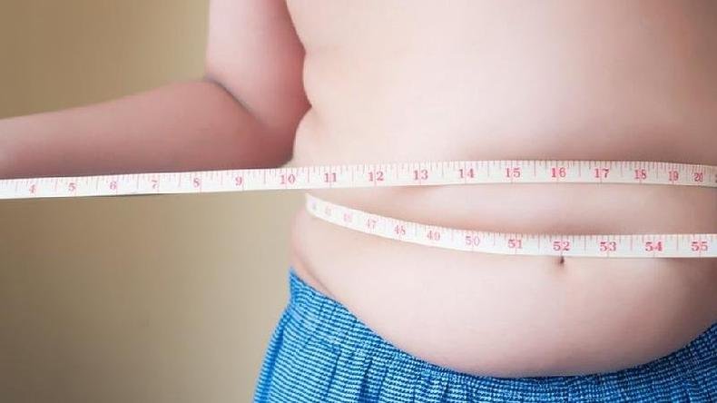 Imagem mostra crian�a com fita m�trica enrolada na cintura