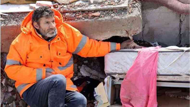 Mesut Hancer segurando a mo da filha morta em meio aos escombros do terremoto