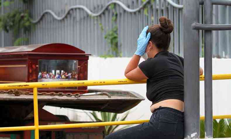 Moradora de Guayaquil se mostra perplexa diante de um caixo deixado na porta de um dos hospitais da cidade(foto: Enrique Ortiz/AFP)
