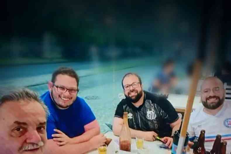 Marcos de Andrade Corsato, 62, Diego Ralf de Souza Bomfim, 35, e Perseu Ribeiro Almeida, 33, e Daniel Sonnewend Proena, 32, nico sobrevivente, aparecem confraternizando, com garrafas e copos de cerveja sobre a mesa