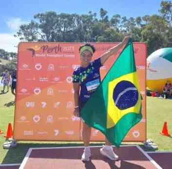 Mulher atleta segurando a bandeira do Brasil