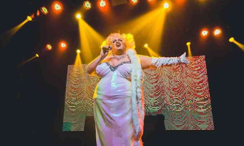 Malonna no palco, vestida de branco de seda e iluminada